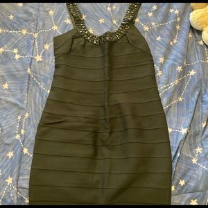 Slim black dress with jeweled straps and neckline